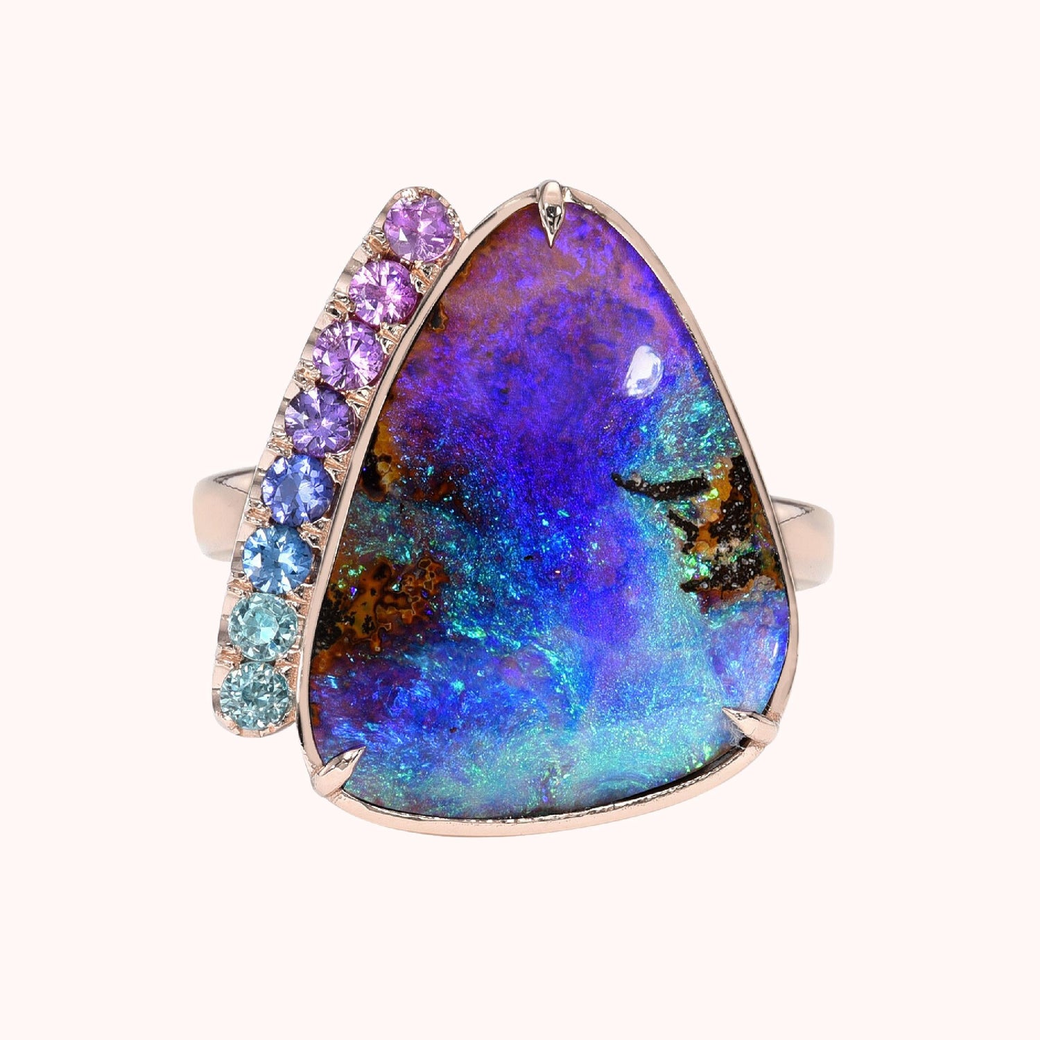 An Australian Opal Ring by NIXIN Jewelry. The rose gold opal ring has a Boulder Opal and purple sapphires..