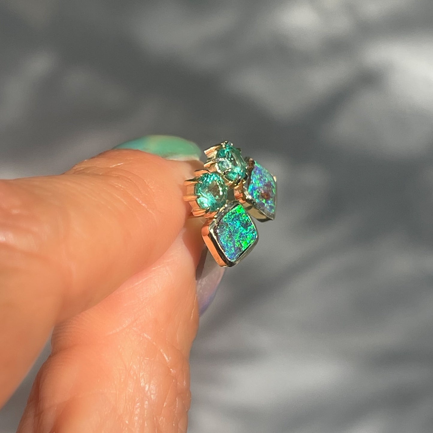 Side view of Australian Opal Earrings by NIXIN Jewelry. Gold opal earrings.