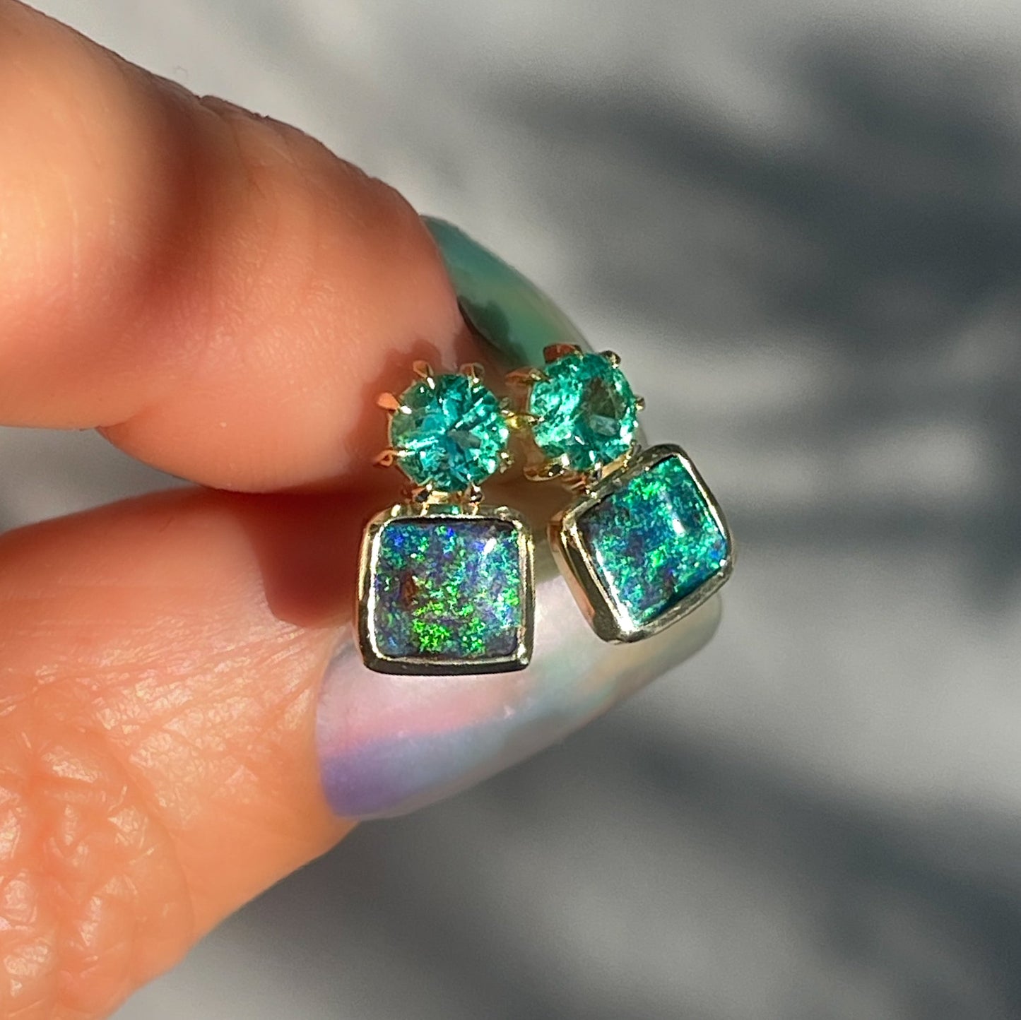 Australian Opal Earrings by NIXIN Jewelry. The Opal studs have emeralds set in claw prongs.
