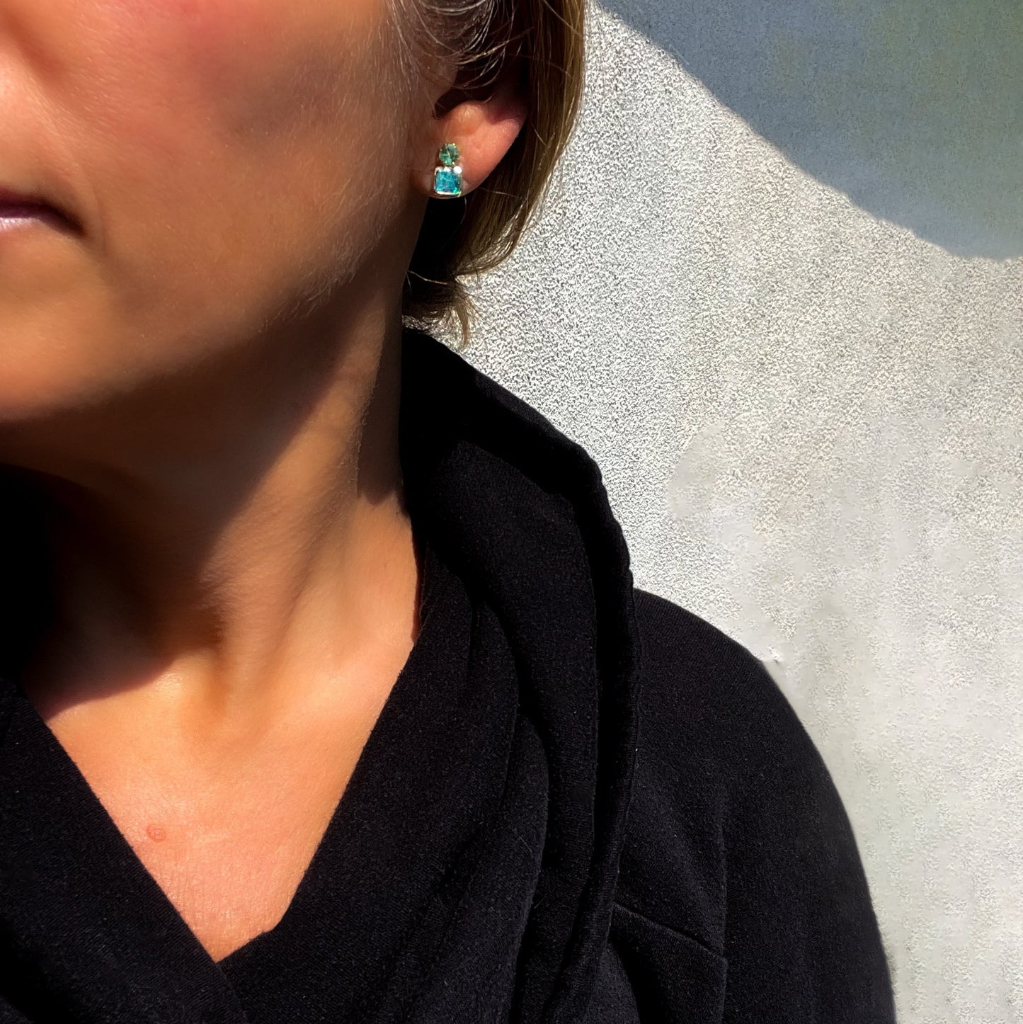 Model wearing Australian Opal Earrings by NIXIN Jewelry to show scale. The emerald earrings are set in 14k gold.
