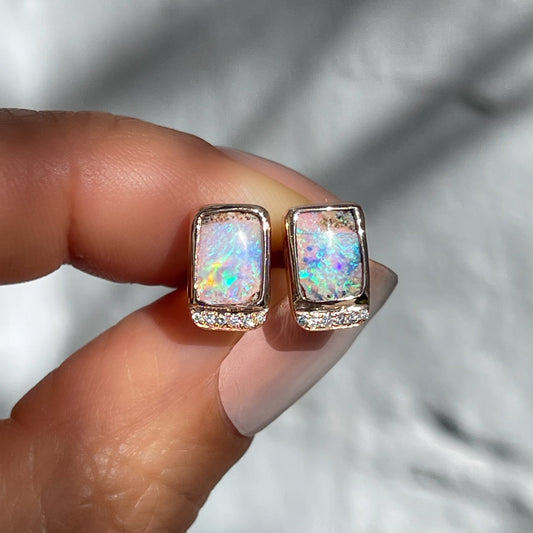 Australian Opal Earrings by NIXIN Jewelry. Crafted as luxury designer earrings, this pair highlights rare earth opals with brilliant diamond detailing.