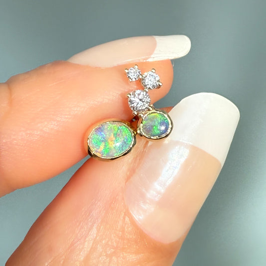 Australian Opal Earrings by NIXIN Jewelry. See the vivid green and blue flash of the black opal jewelry set in 14k gold. This is jewelry art featuring rare opal jewelry for collectors searching for opal jewelry for sale.