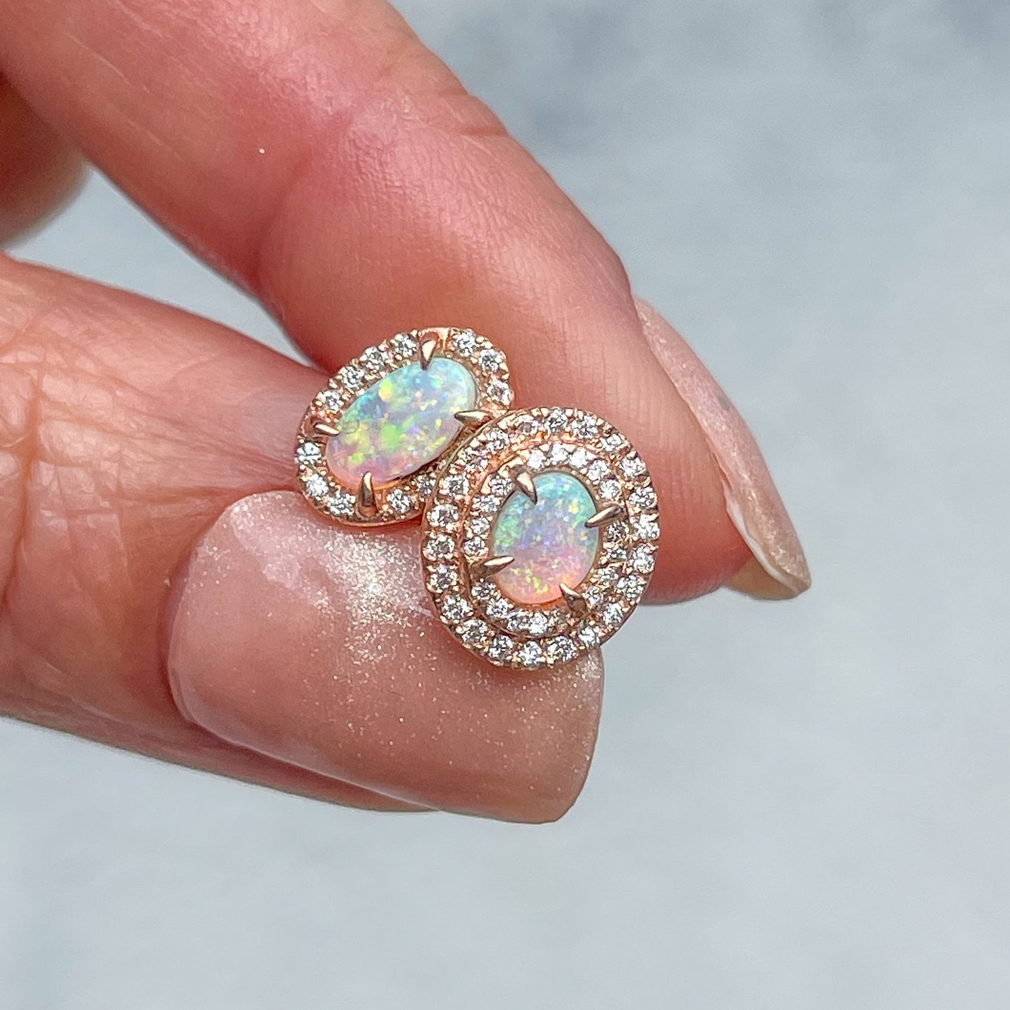 A pair of Australian Opal Earrings by NIXIN Jewelry with diamonds and 14k rose gold setting.