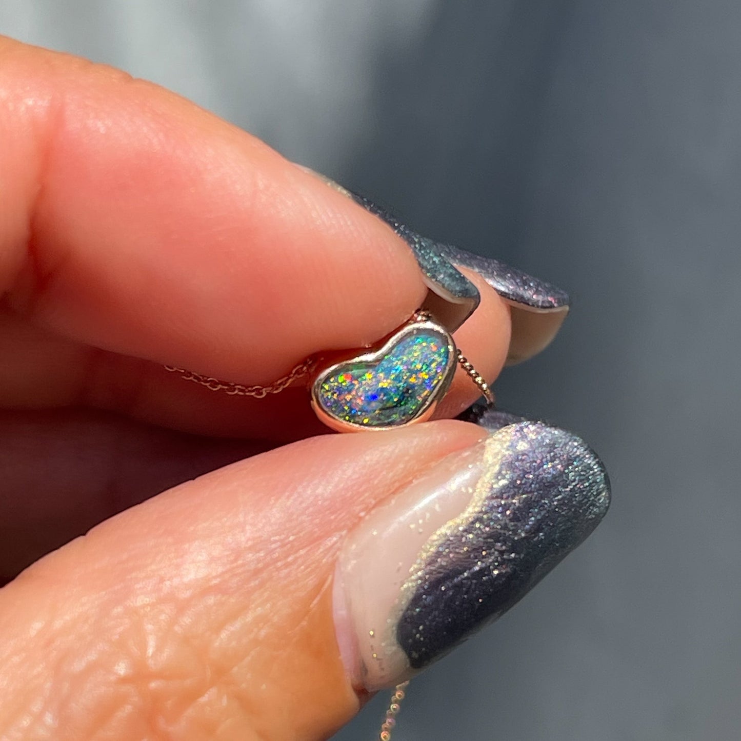 An Australian Opal Necklace by NIXIN Jewelry. The Black Opal necklace is a heart pendant.