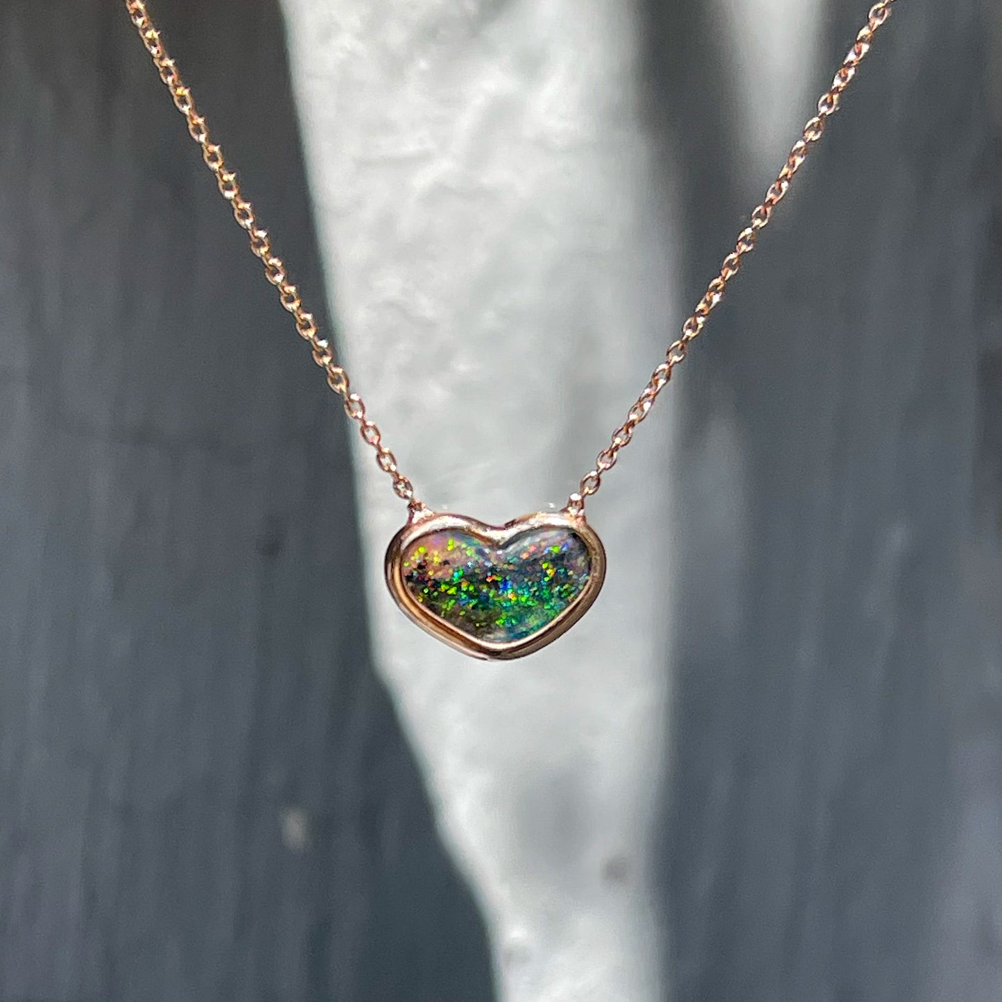 An Australian Opal Necklace by NIXIN Jewelry. The opal heart necklace is set in 14k rose gold.