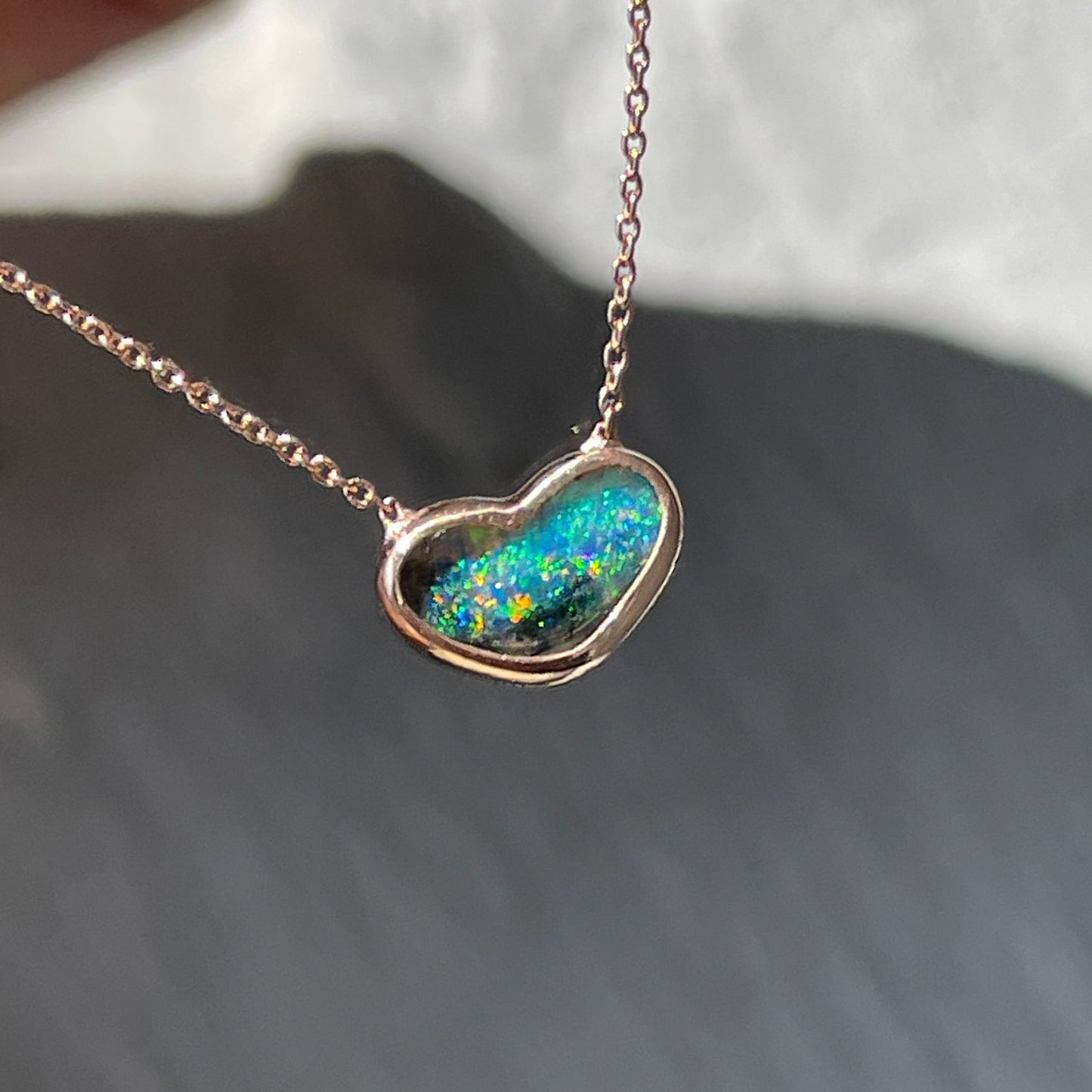 An Australian Opal Necklace by NIXIN Jewelry made with a Lightning Ridge Opal set in rose gold.