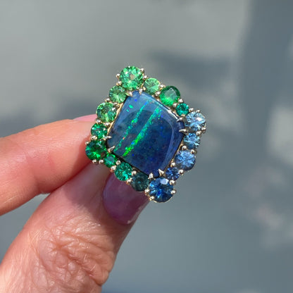 An Australian Opal Ring by NIXIN Jewelry. An opal and emerald ring with green garnets and sapphires.