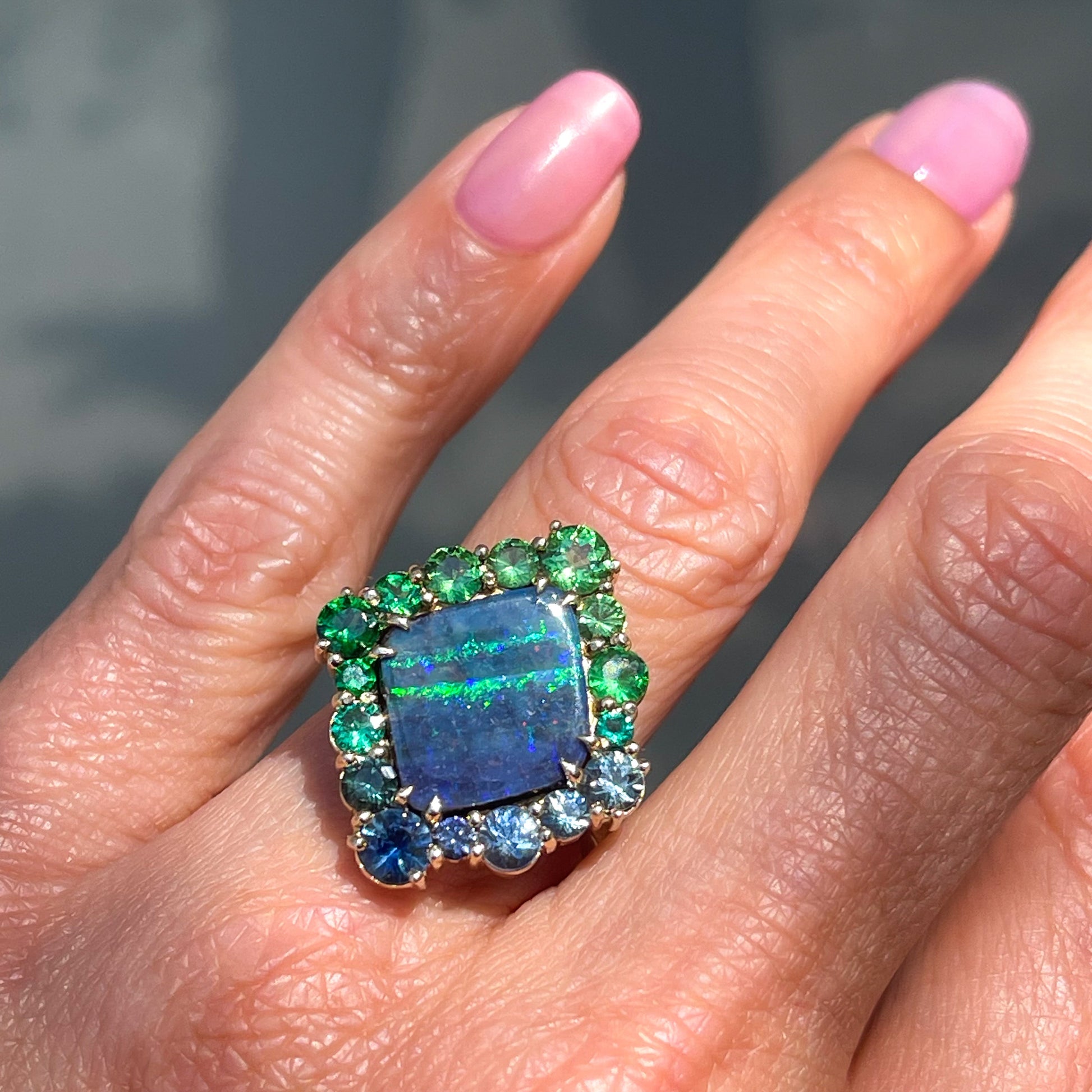 An Australian Opal Ring by NIXIN Jewelry. An opal and sapphire ring with garnets and emeralds.