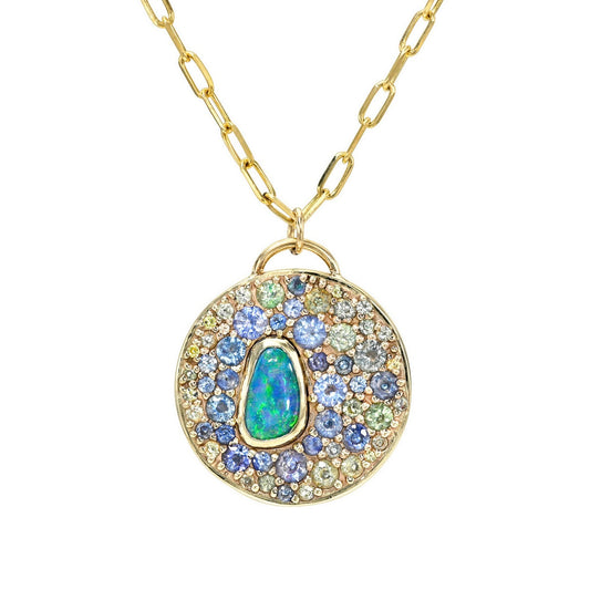 An Australian Opal Necklace by NIXIN Jewelry featuring a bezel-set boulder opal surrounded by blue, teal, and green sapphires. A luxury necklace highlighting a natural opal paired with rare gemstones in an artistic pendant.