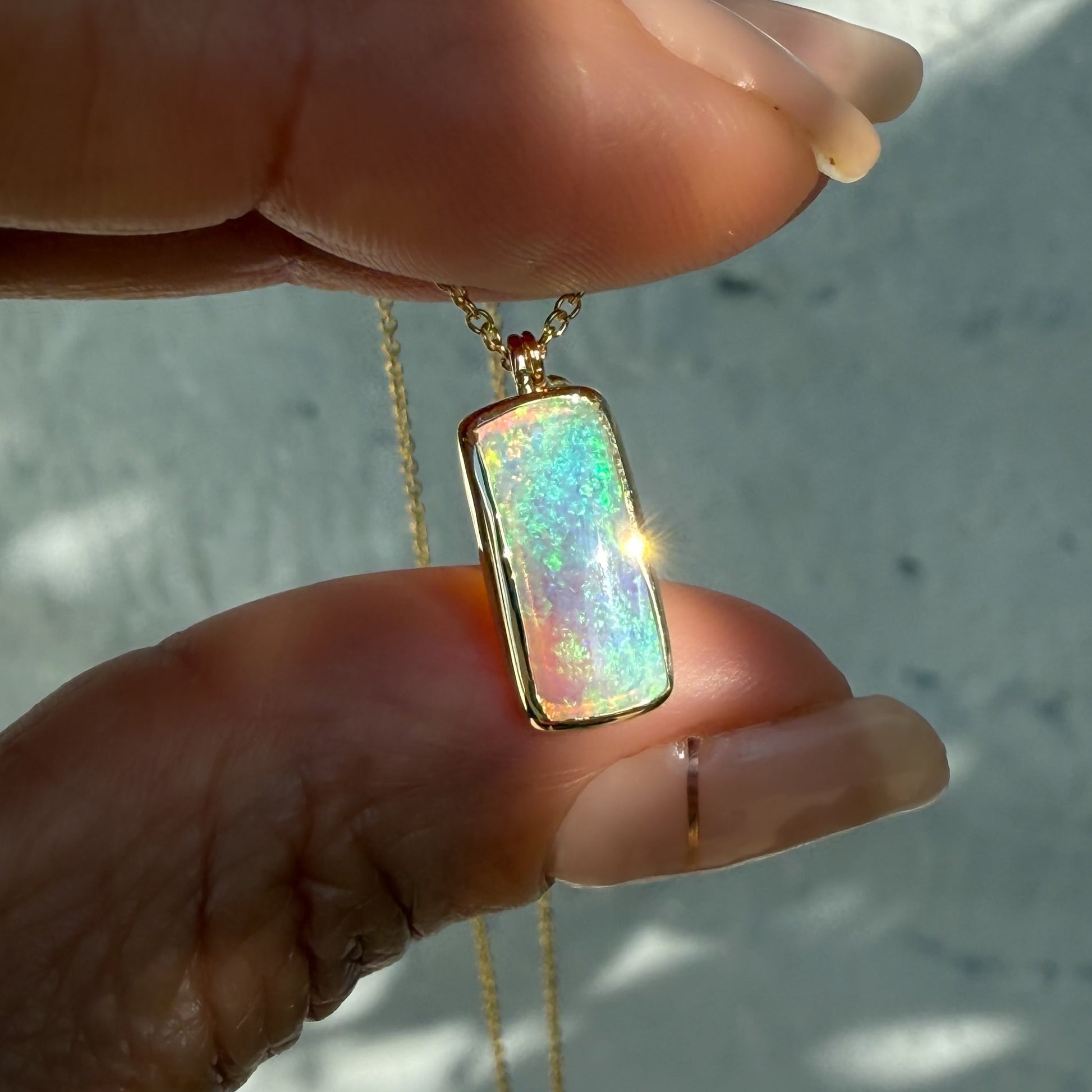 An Australian Opal Necklace by NIXIN Jewelry. This opal pendant necklace features a crystal opal. A piece of women's luxury jewelry.