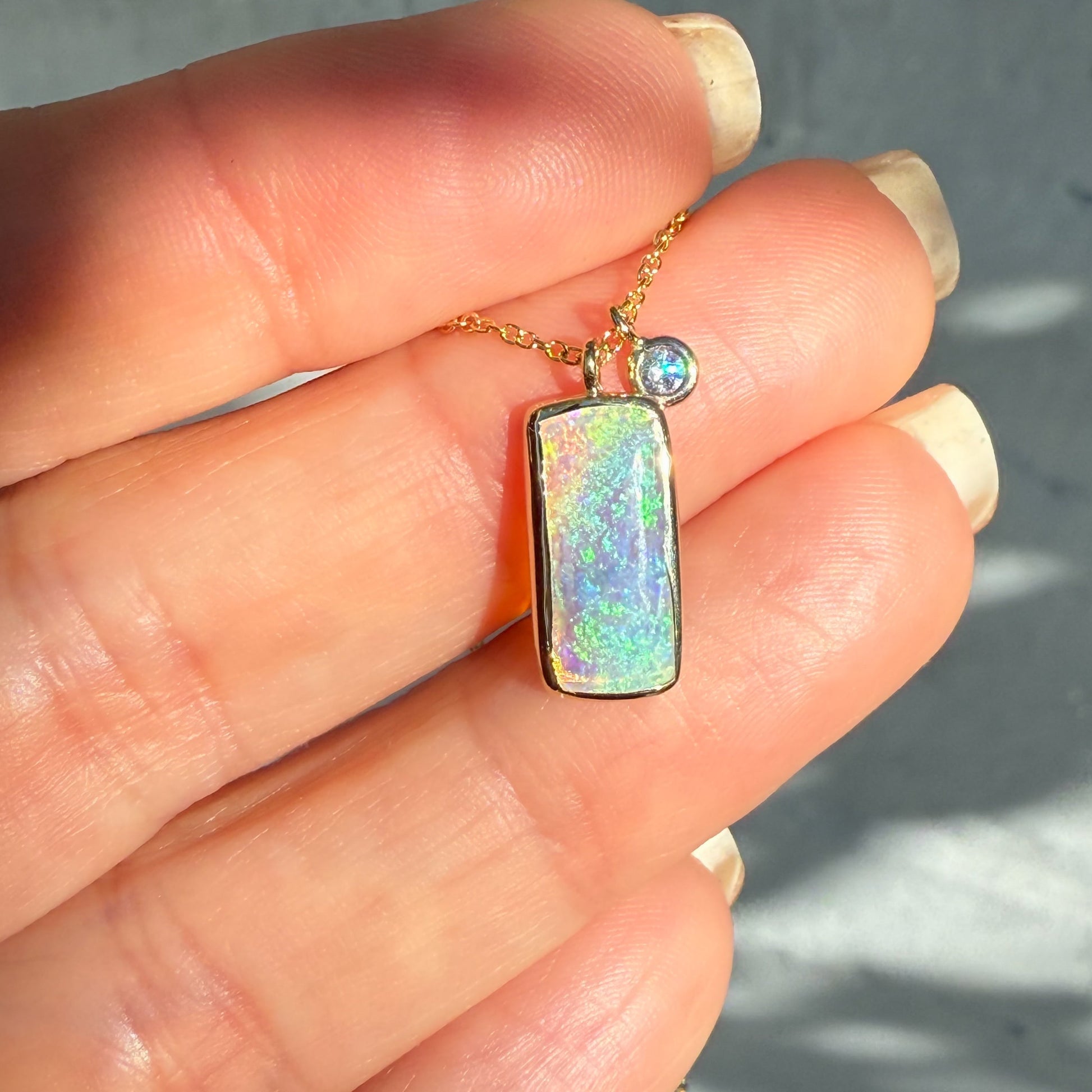 An Australian Opal Necklace by NIXIN Jewelry. This opal pendant features a Coober Pedy opal. The rare jewelry design highlights the unique opal jewelry, perfect for those seeking rare opal necklaces.