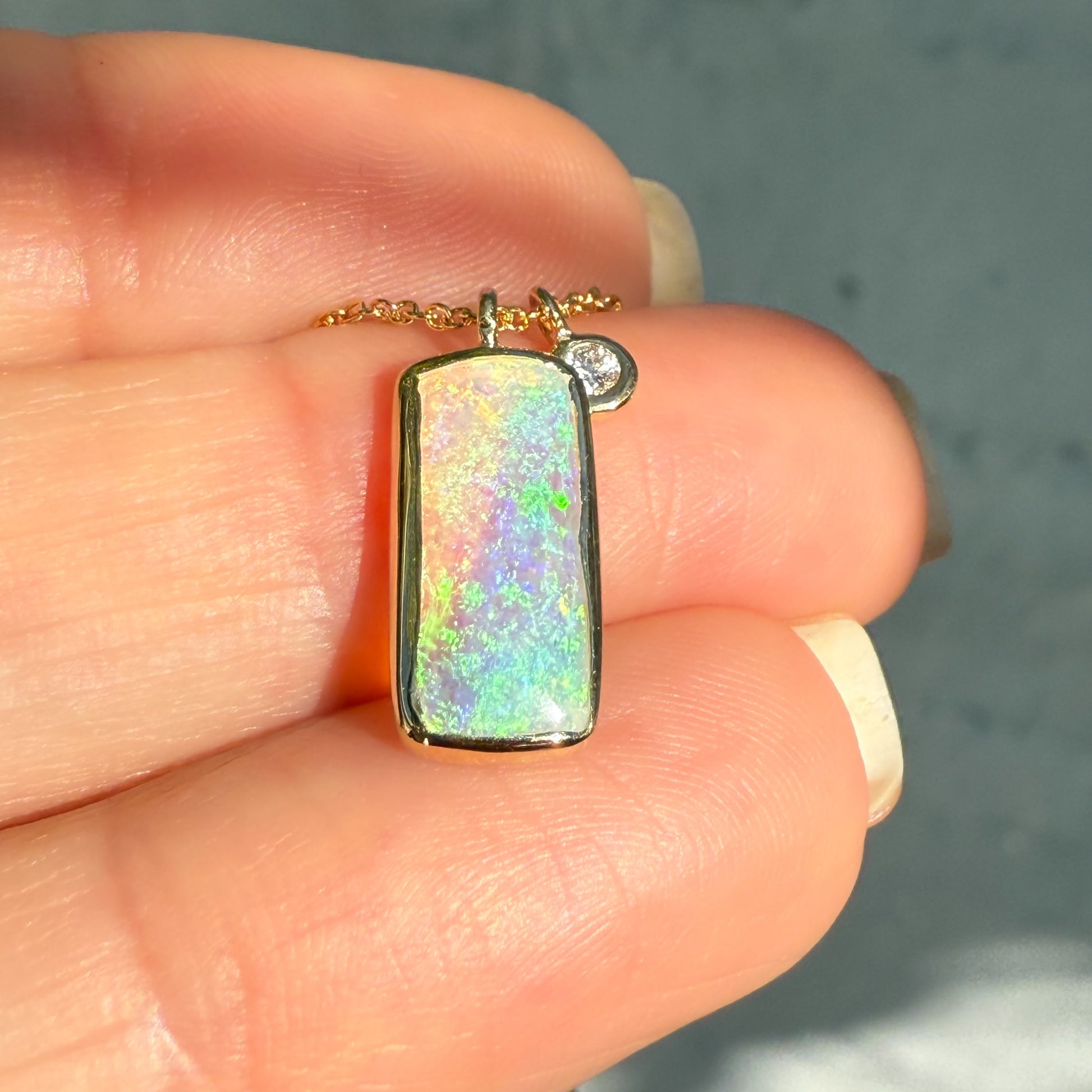 An Australian Opal Necklace by NIXIN Jewelry. This opal and diamond pendant features a rare opal stone. The opal necklace is an example of unique fine jewelry.