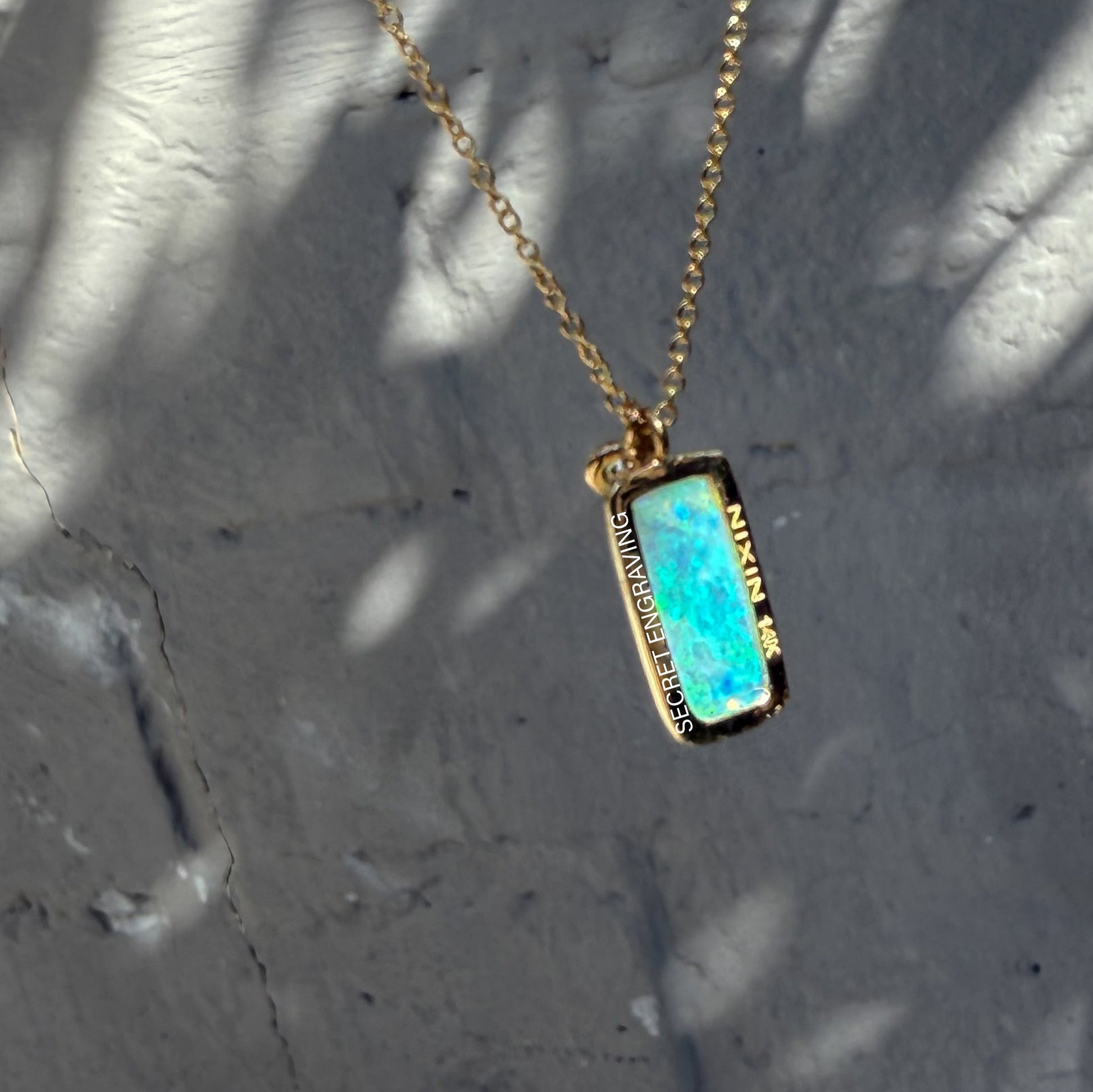 The back of an Australian Opal Necklace by NIXIN Jewelry. This women's luxury necklace showcases a stunning crystal opal pendant. The opal stone and the gold setting make for a perfect combination of luxury and natural beauty, an excellent choice for a rare opal necklace.