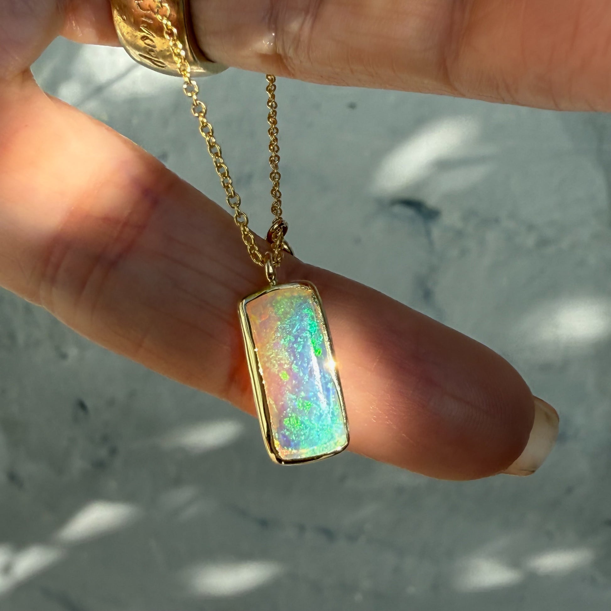 An Australian Opal Necklace by NIXIN Jewelry. This opal pendant necklace is a work of jewelry art, with a beautiful opal stone. The unique opal necklace is designed for those who appreciate fine, one-of-a-kind accessories.