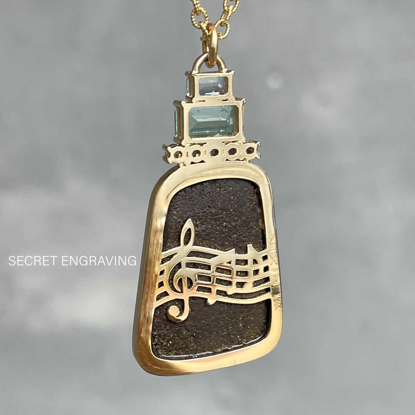 Back view of an Australian Opal Necklace by NIXIN Jewelry. Image shows gold notes on the back and indicates location of secret engraving.