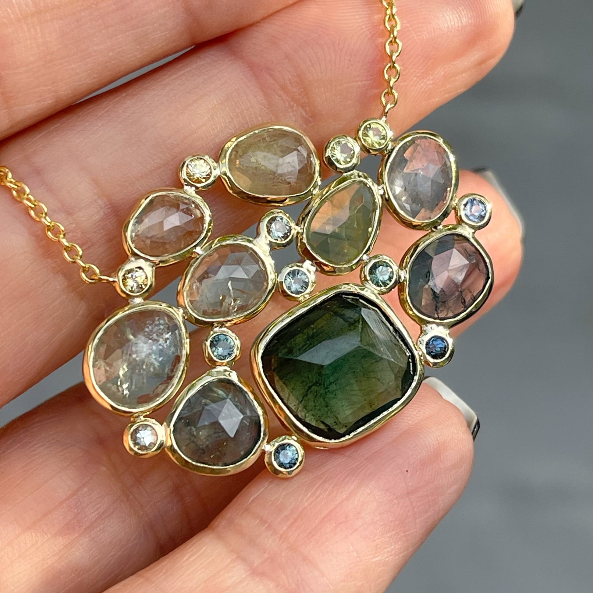  A Tourmaline and Sapphire Necklace by NIXIN Jewelry in 14k gold.
