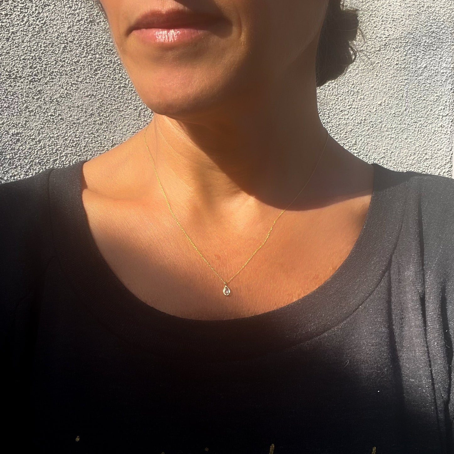 A model wearing a Dainty Diamond Necklace by NIXIN Jewelry to show scale.