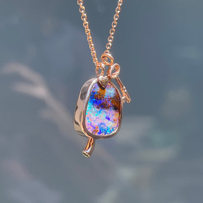 Side view of an Australian Opal Necklace by NIXIN Jewelry. Image shows the bezel setting of the opal pendant.