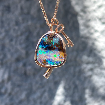 An Australian Opal Necklace by NIXIN Jewelry made in rose gold with a green and blue opal.