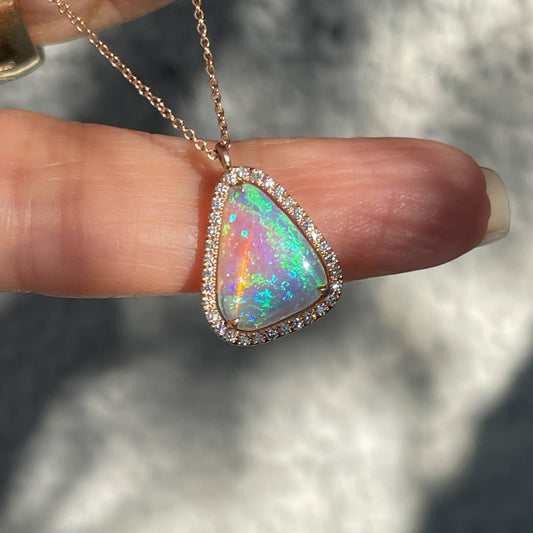 An Australian Opal Necklace by NIXIN Jewelry. An opal pendant with a diamond halo.