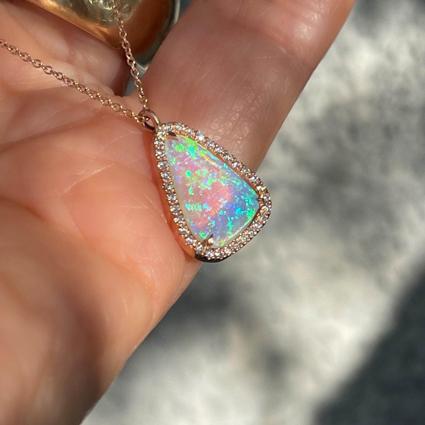 Side view of a Australian Opal Necklace by NIXIN Jewelry. A unique opal necklace with diamonds.