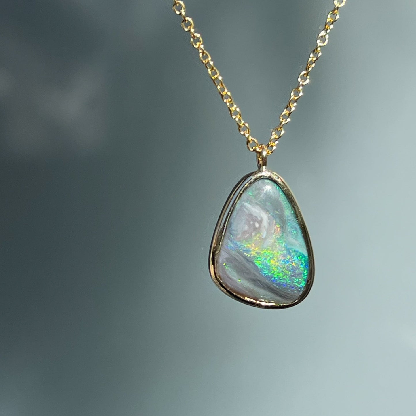 An Australian Opal Necklace by NIXIN Jewelry. The opal pendant is bezel set with a Lightning Ridge Opal.