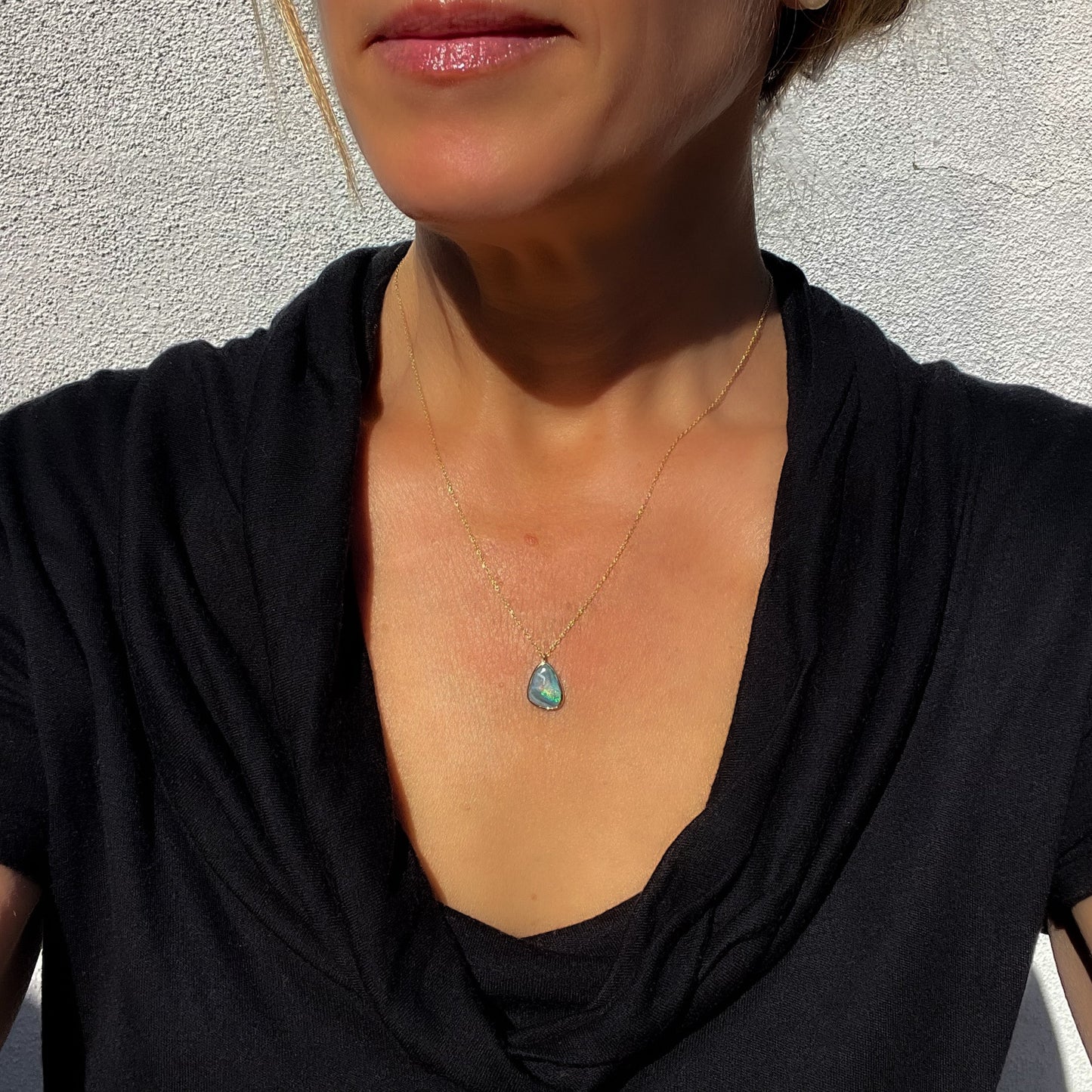 Model wearing an Australian Opal Necklace by NIXIN Jewelry to show scale. Available on NIXINjewelry.com with other unique opal jewelry.