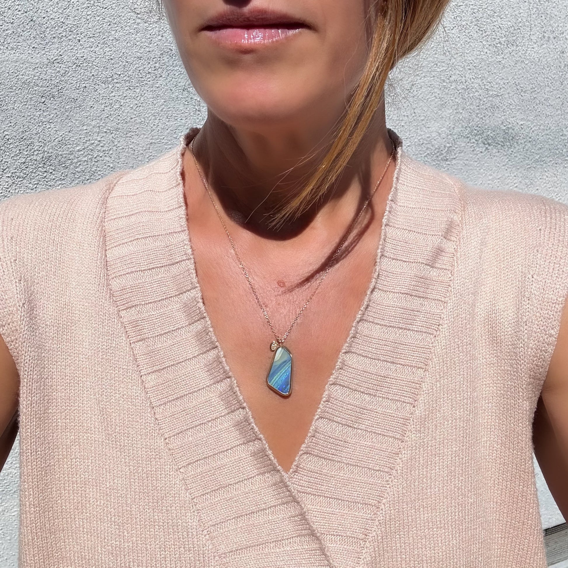An Australian Opal Necklace by NIXIN Jewelry on a model's neck, displaying the length and scale of the opal and diamond necklace.