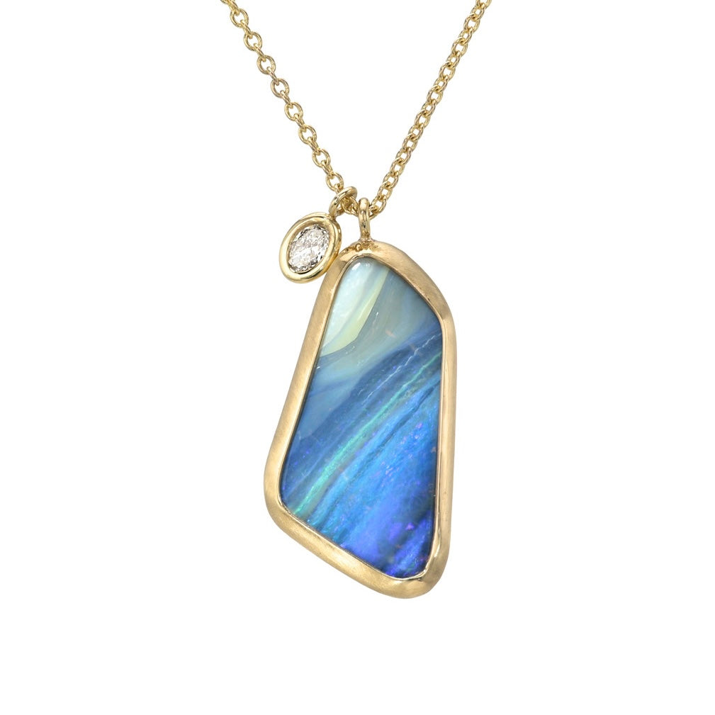 An Australian Opal Necklace by NIXIN Jewelry featuring a boulder opal pendant with a blue opal set in a clean bezel setting. This opal and diamond necklace is a statement piece of unique jewelry.