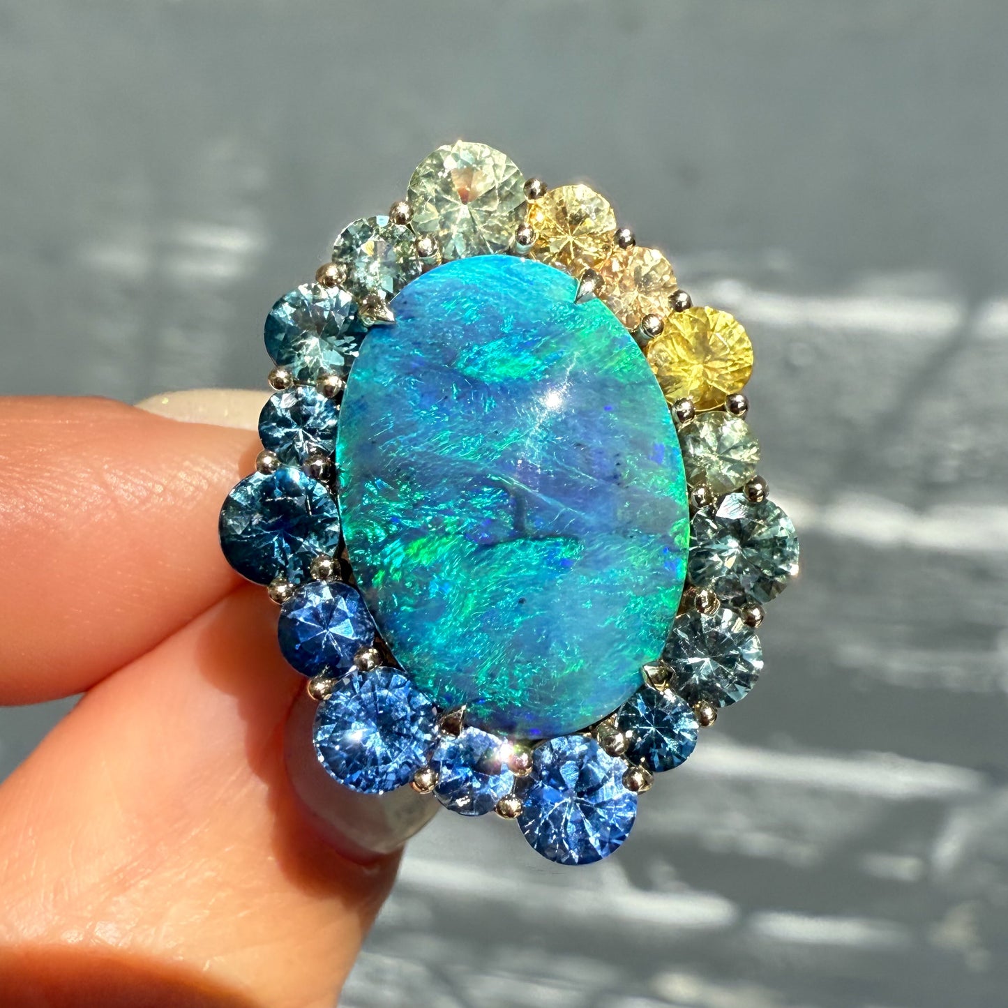 An Australian Opal Ring by NIXIN Jewelry. This rare opal ring features a black opal with intense blue and green flashes. It is a one-of-a-kind piece of luxury jewelry.