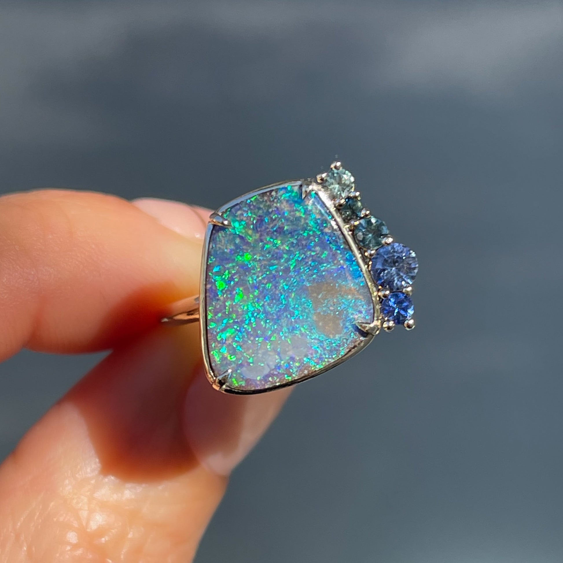 An Australian Opal Ring by NIXIN Jewelry made with a boulder opal and sapphires. One of the rare opal rings for women at nixinjewelry.com .