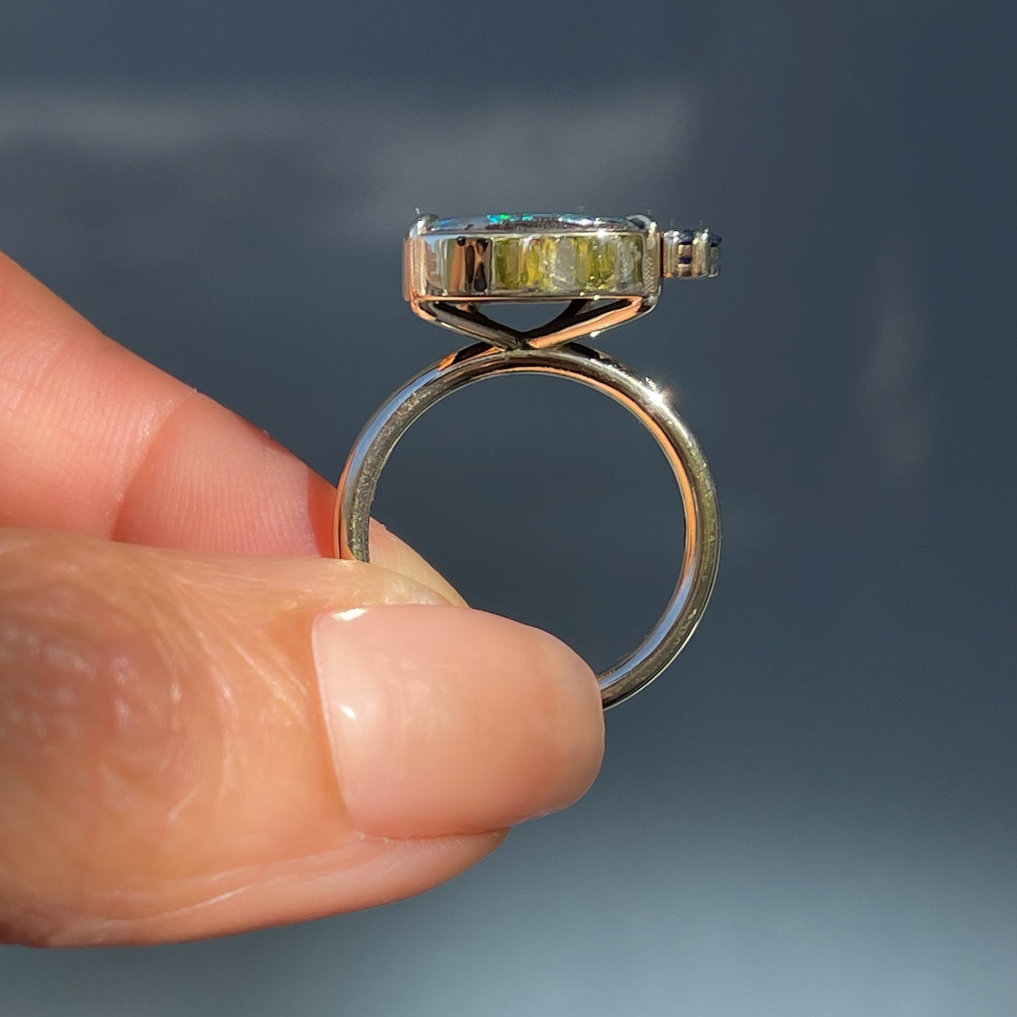 Profile shot of an Australian Opal Ring by NIXIN Jewelry. A gold opal ring that is unique fine jewelry.