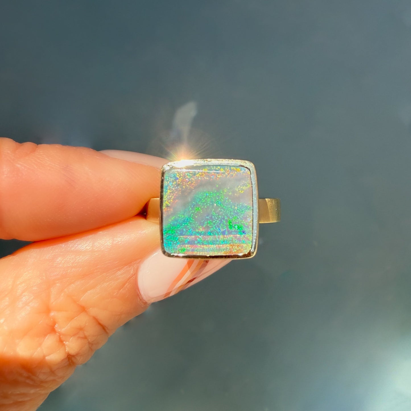An Australian Opal Ring by NIXIN Jewelry, showcasing unique opal jewelry. This luxury ring features a vibrant blue opal, ideal as a statement or cocktail ring.