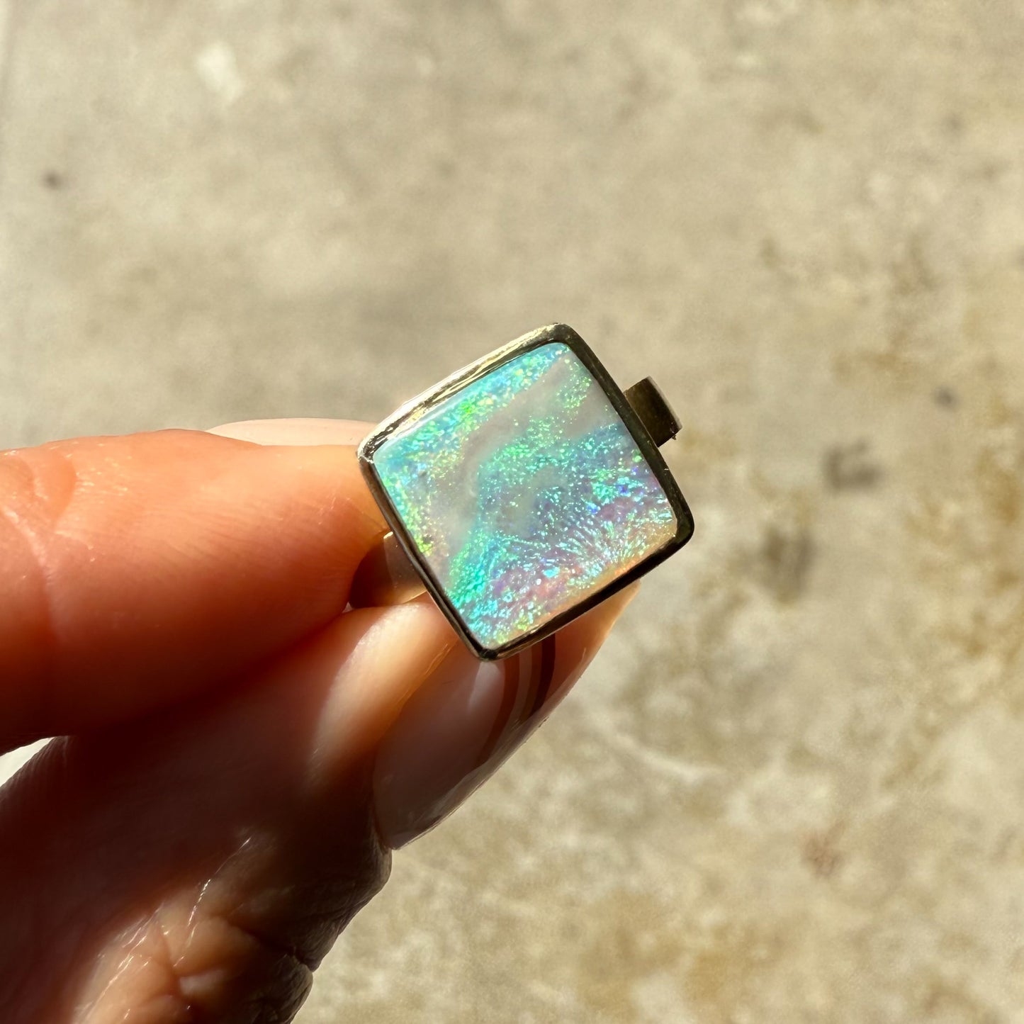 An Australian Opal Ring by NIXIN Jewelry, designed for the discerning. This women's luxury ring features a captivating black opal in a sturdy bezel setting.