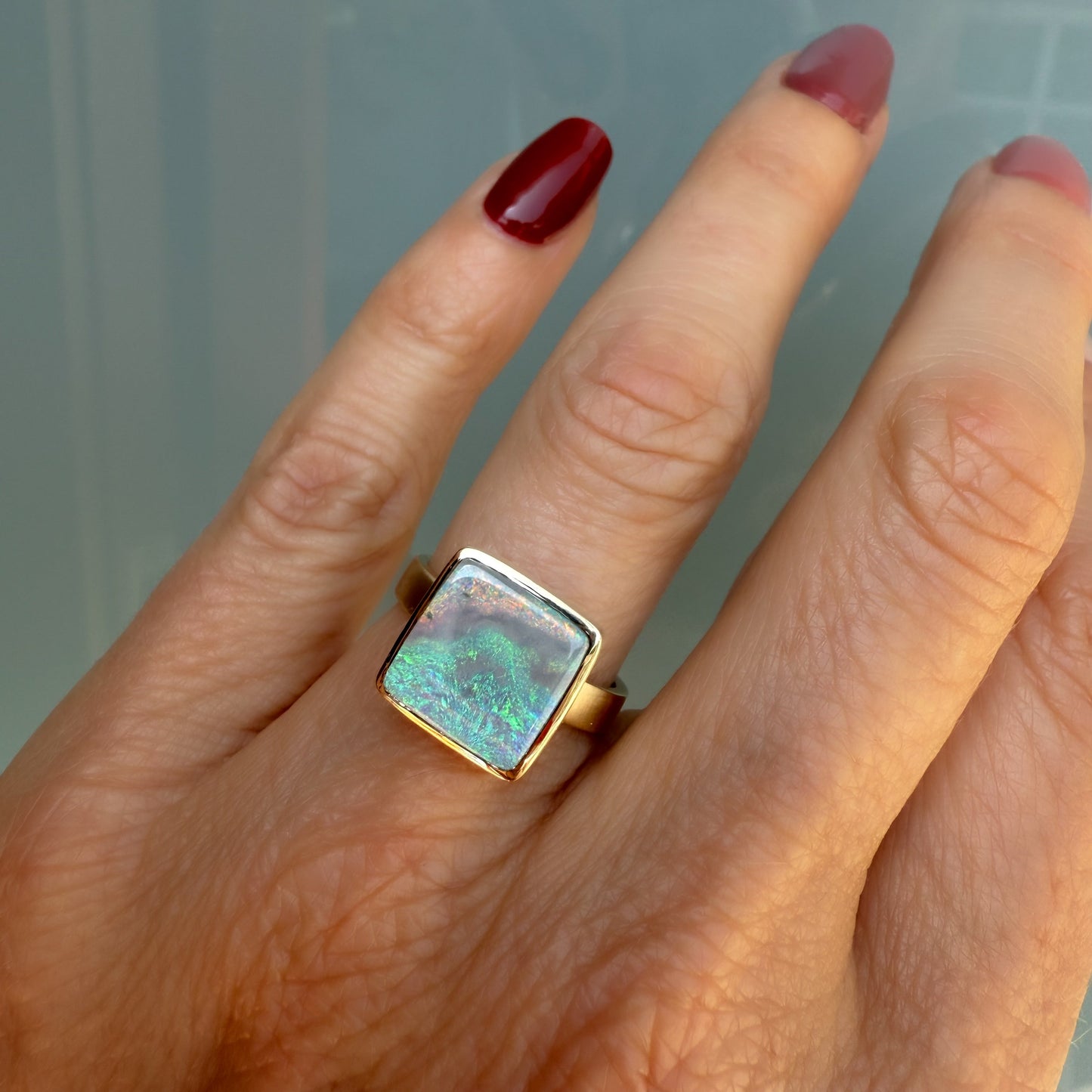 An Australian Opal Ring by NIXIN Jewelry, highlighting a beautiful blue opal. This rare opal jewelry piece offers unparalleled brilliance and a unique look.