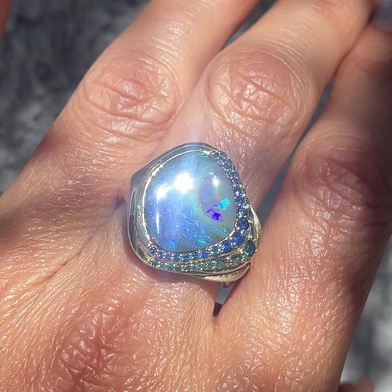 Video of Australian Opal Ring by NIXIN Jewelry modeled on hand. Gold sapphire and opal ring.