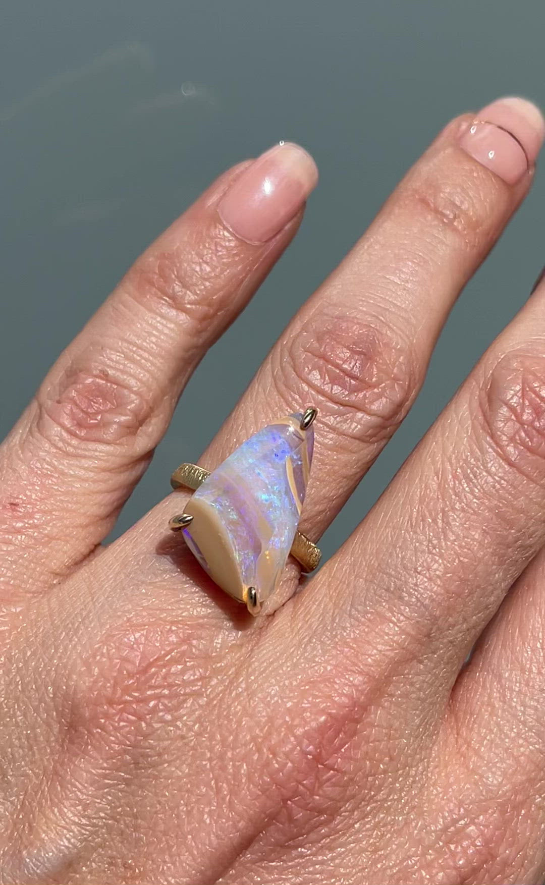 Video of crystal opal ring by NIXIN Jewelry modeled in sunlight