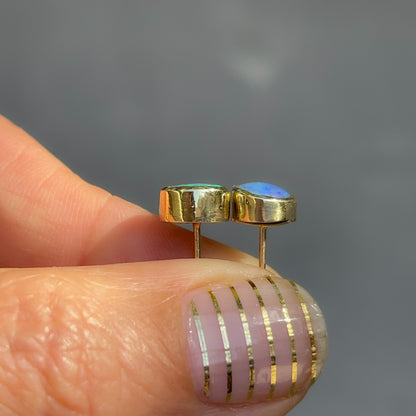 Profile view of 14k gold opal stud earrings by NIXIN Jewelry