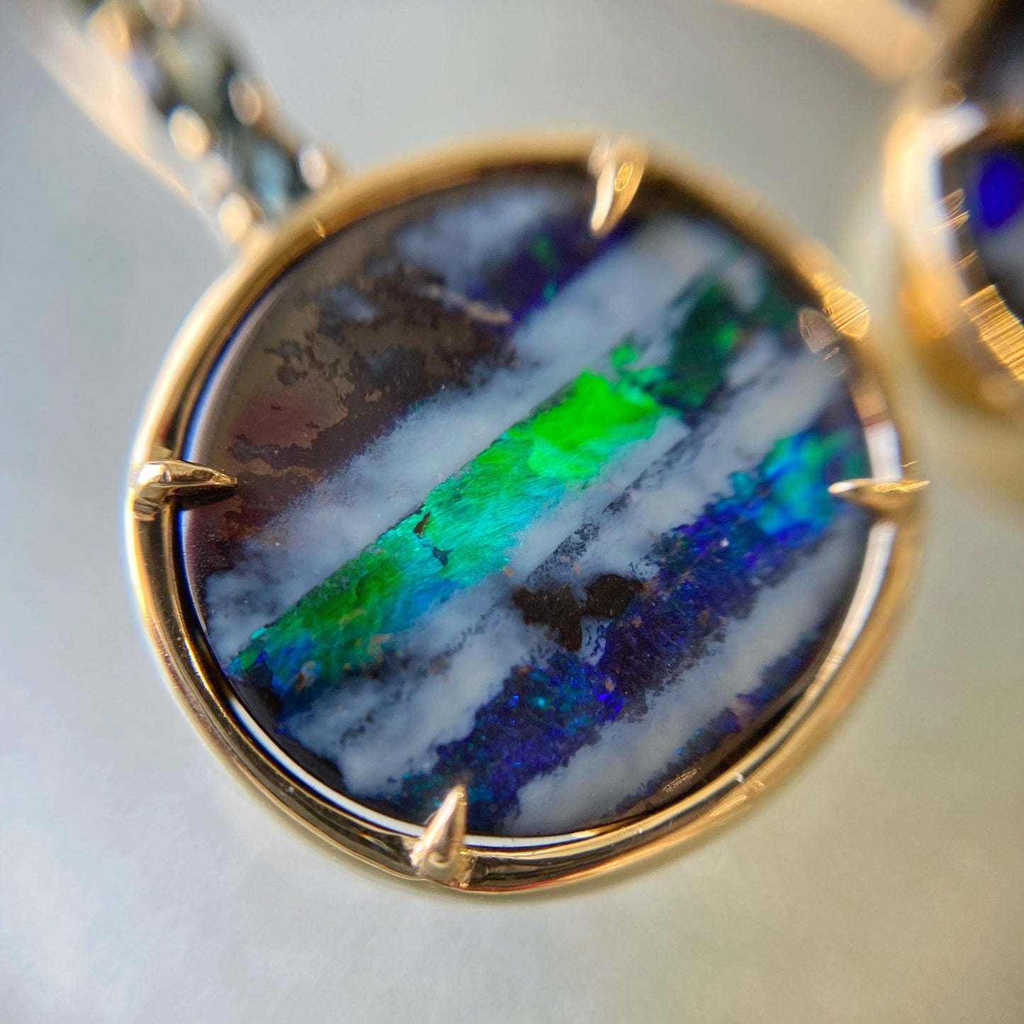 Close up of real opal earrings with green and blue boulder opals by NIXIN Jewelry