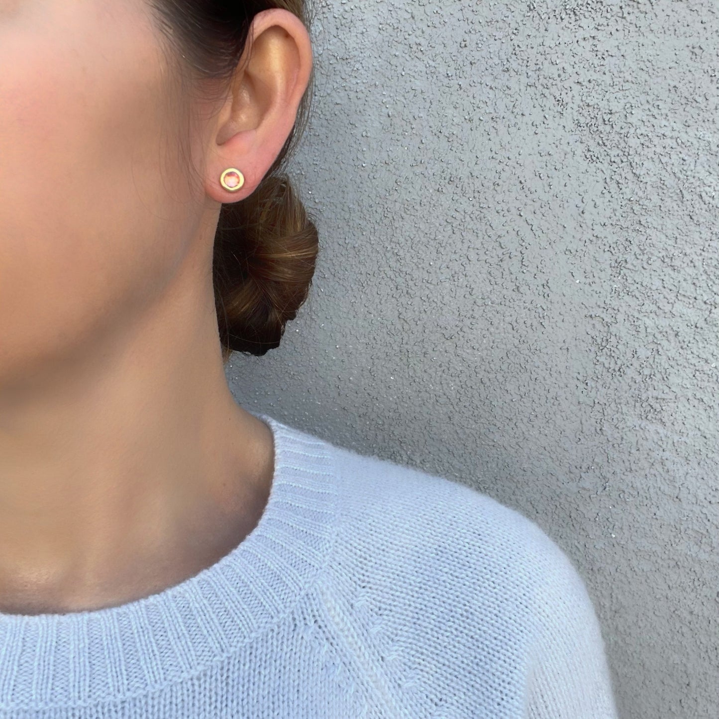 Model wearing pink sapphire studs by NIXIN Jewelry