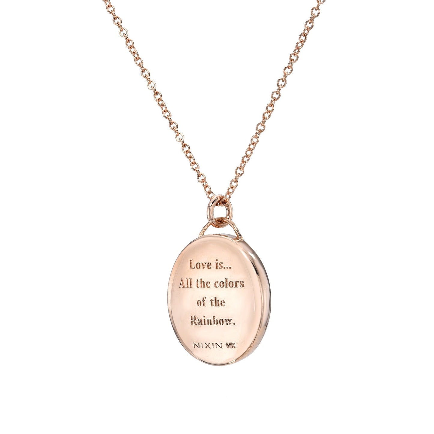 A view of the love note engraved on the back of anAustralian Opal Necklace by NIXIN Jewelry. Shot in front of a white backdrop.