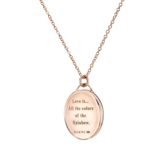 A view of the love note engraved on the back of anAustralian Opal Necklace by NIXIN Jewelry. Shot in front of a white backdrop.