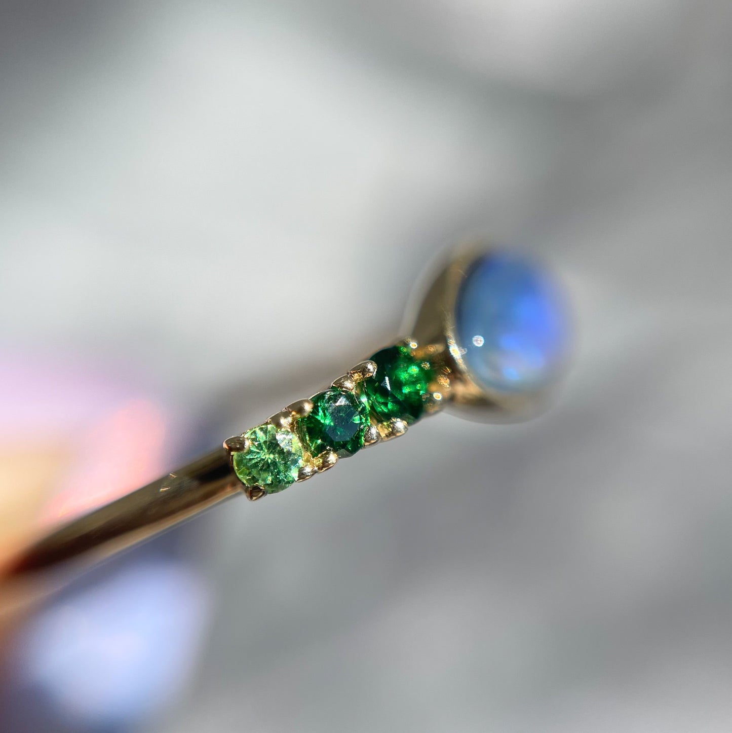 Black Opal Ring by NIXIN Jewelry shot from side. Garnet and opal ring.