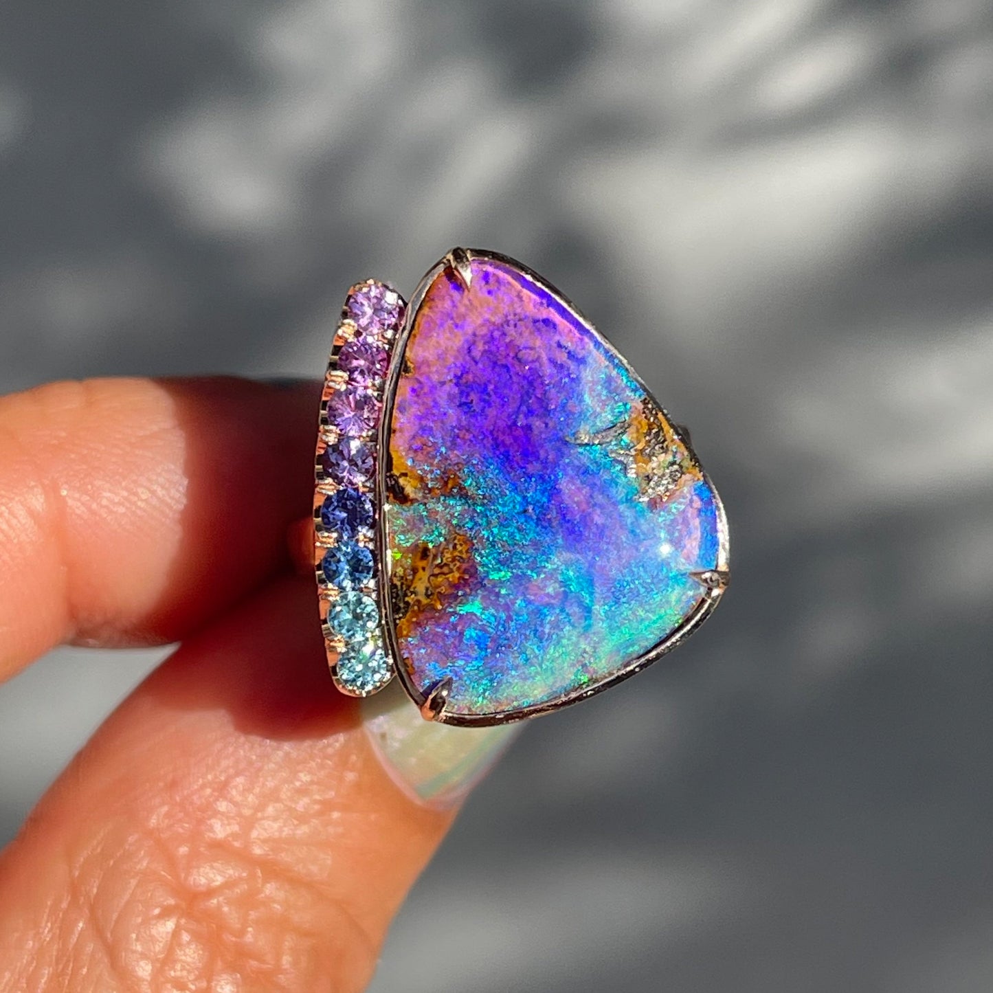 An Australian Opal Ring by NIXIN Jewelry features a lavender opal in 14k rose gold.