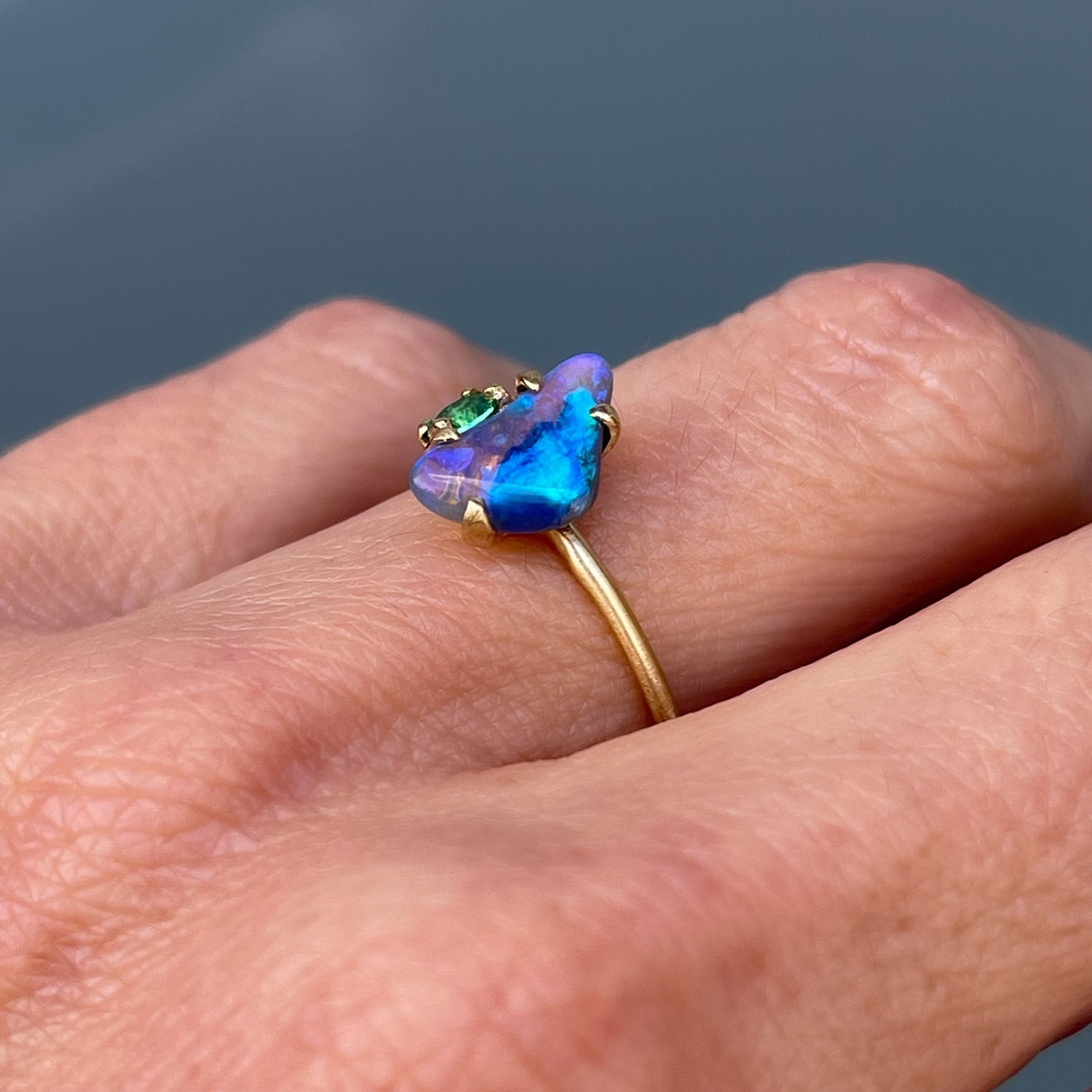 Australian black opal ring by NIXIN Jewelry on hand shown from angle