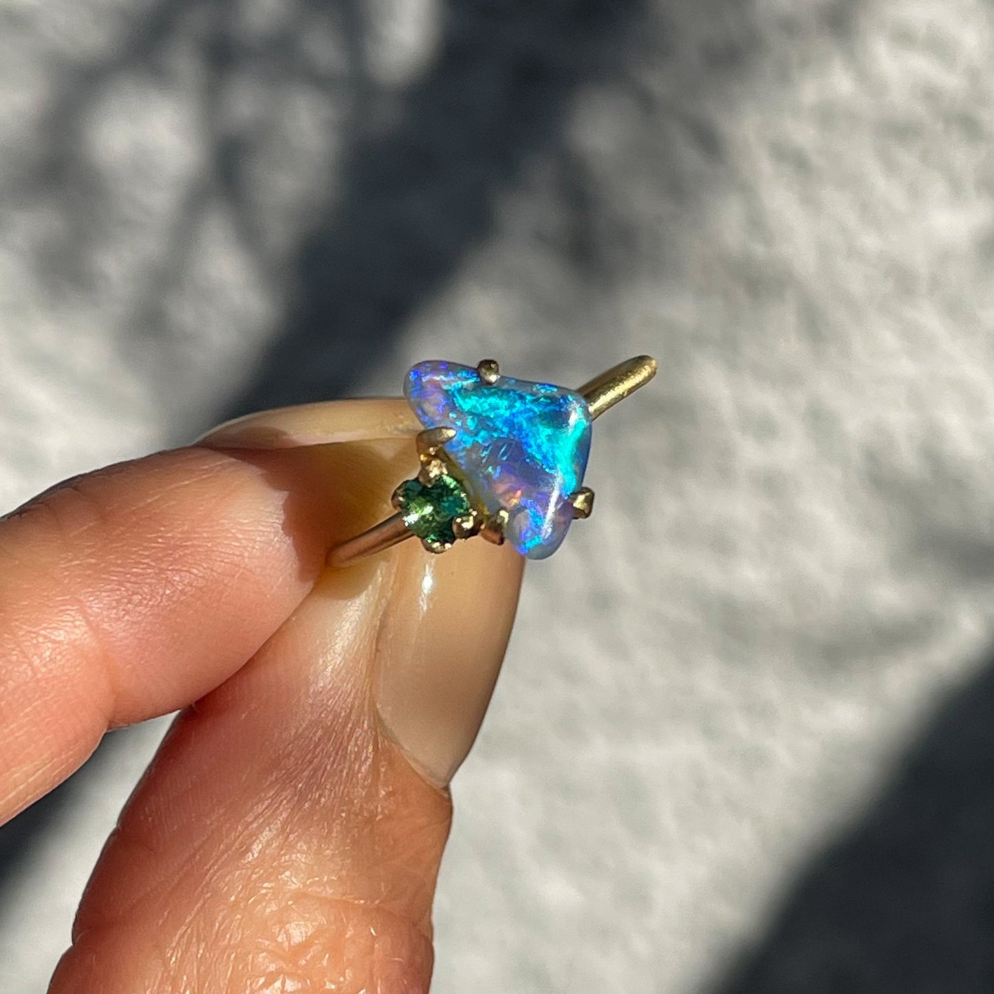 Natural opal ring by NIXIN Jewelry shot in sunlight