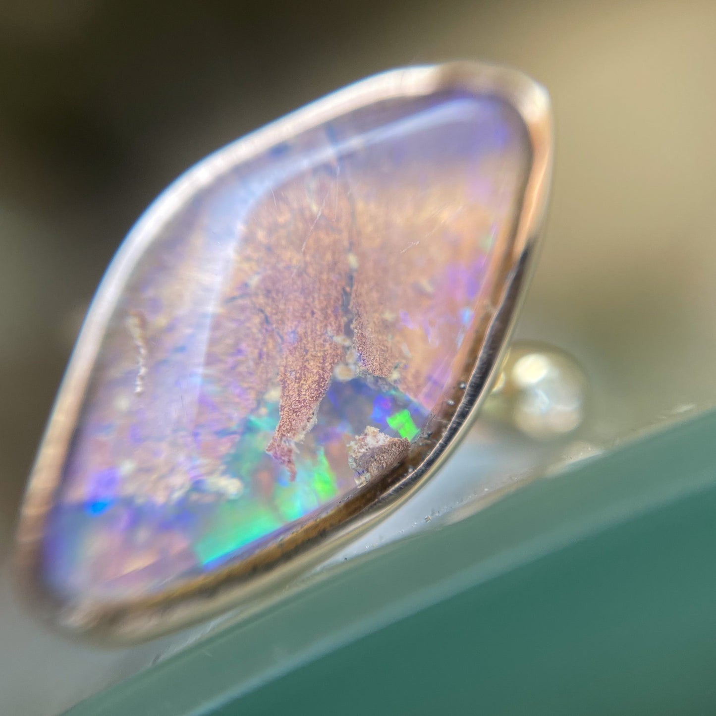 Zion Dali Australian Opal Ring by NIXIN Jewelry shown magnified and in shade. Simple opal ring.