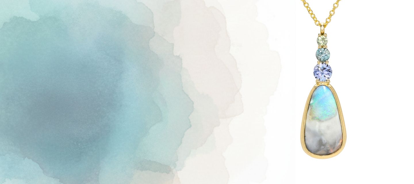 An Australian Opal Pendant by NIXIN Jewelry. The gold opal pendant is in a bezel setting with three sapphires in ombre hues. A rare luxury necklace.