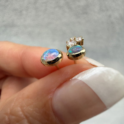 Australian Opal Earrings by NIXIN Jewelry. Profile view of the opal studs, highlighting the stunning play-of-color, including bright pink and blue, in the crystal opal and black opal. We offer rare opal jewelry and unique opal jewelry for sale.