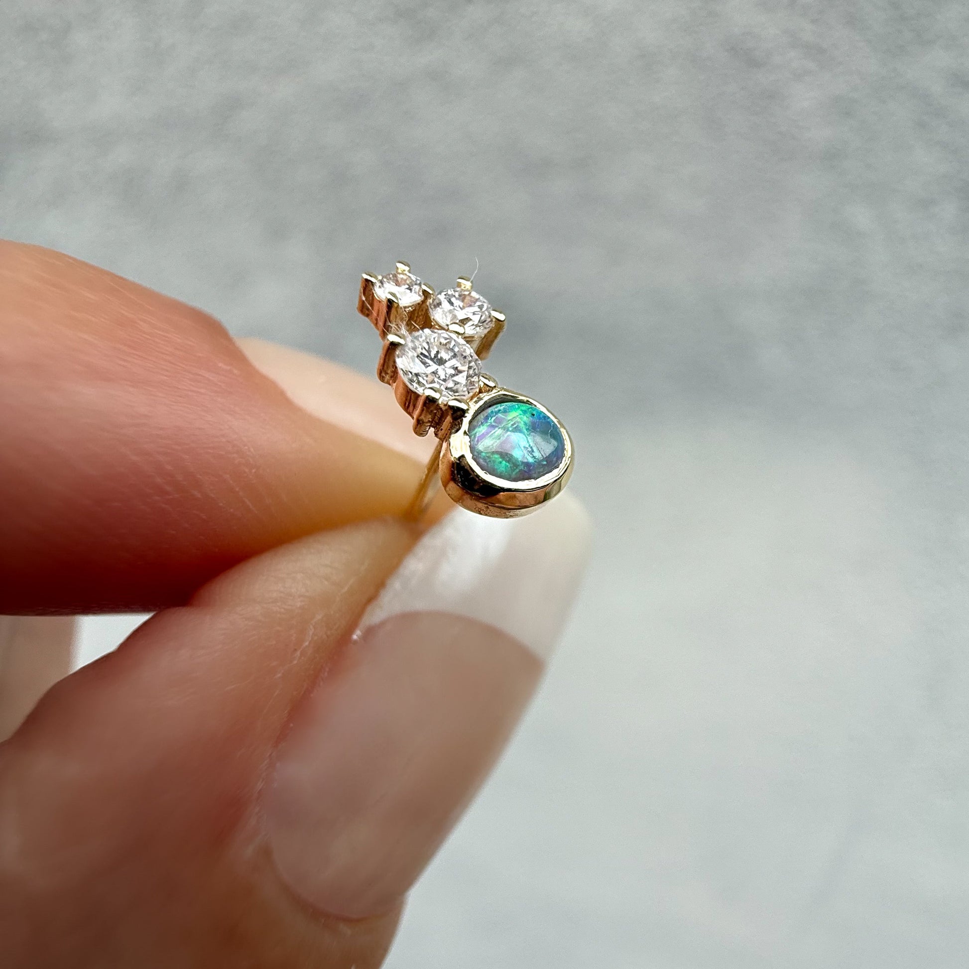 Australian Opal Earrings by NIXIN Jewelry. Extreme close-up of the smaller opal diamond earrings stud, featuring the black crystal opal and diamond cluster. This unique jewelry piece is an excellent example of modern opal jewelry and fine jewelry art.